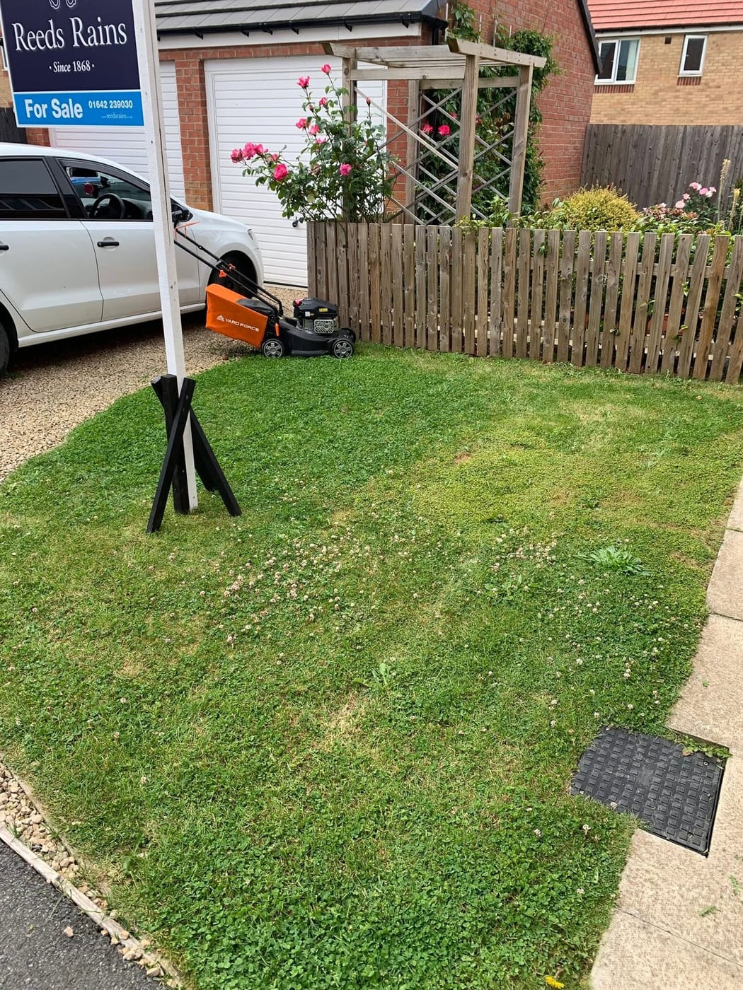 The front lawn cut, with the mower beside the drive