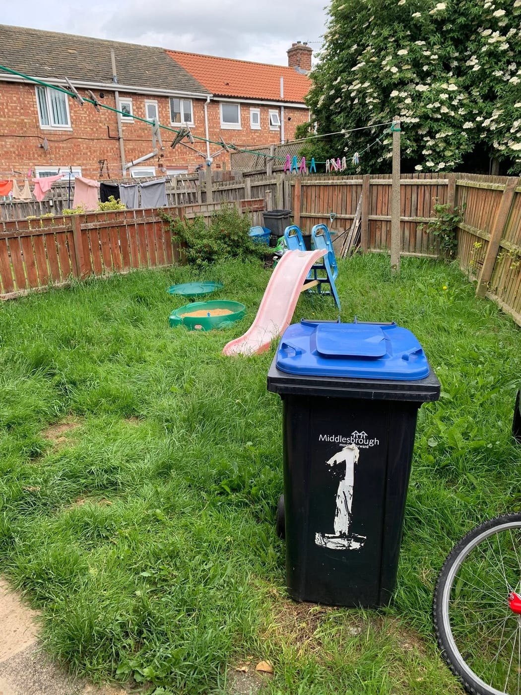 A long, neatly trimmed hedge around a freshly cut lawn in Park End